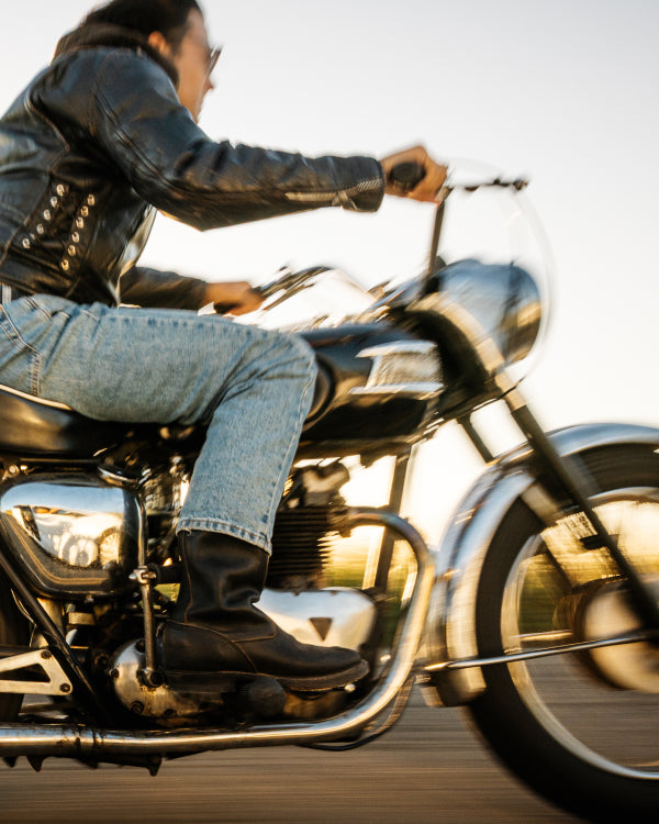 Person riding a motorcycle with a blurred background